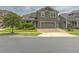 Inviting two-story home featuring a well-manicured lawn and a brick paved driveway leading to a two car garage at 3302 Stonegate Dr, Ocoee, FL 34761