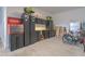 Organized garage with storage cabinets, workbench, tools, and bicycles at 3302 Stonegate Dr, Ocoee, FL 34761