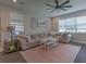 Bright living room featuring a cozy sofa, natural light, and neutral tones creating a relaxing atmosphere at 3302 Stonegate Dr, Ocoee, FL 34761