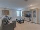 Upstairs living room with a cozy sofa, entertainment center, and a large TV at 3302 Stonegate Dr, Ocoee, FL 34761