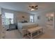 Bright main bedroom features a king bed, ceiling fan, and ensuite bathroom at 3302 Stonegate Dr, Ocoee, FL 34761