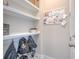 Mudroom with shelves, hooks for bags, and a message board, offering practical storage at 3302 Stonegate Dr, Ocoee, FL 34761