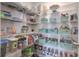 Well-organized pantry with multiple wire shelves filled with food items and storage baskets at 3302 Stonegate Dr, Ocoee, FL 34761