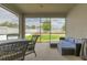 Covered patio featuring a wicker dining set and a cozy blue cushioned sofa, perfect for outdoor lounging at 3302 Stonegate Dr, Ocoee, FL 34761