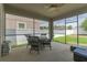 Screened-in patio with a wicker dining set, offering a comfortable outdoor space for dining and relaxation at 3302 Stonegate Dr, Ocoee, FL 34761