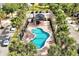 Scenic aerial view of community pool area with lounging and shaded cabana at 10374 Park Commons Dr, Orlando, FL 32832