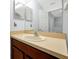 Bathroom with a single sink vanity and a large mirror reflecting the open door at 10374 Park Commons Dr, Orlando, FL 32832
