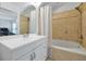 Bathroom featuring tub and shower combo with white vanity and an arched mirror at 10374 Park Commons Dr, Orlando, FL 32832