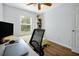 Well-lit bedroom with a workspace, hardwood floors, and a neutral color scheme at 10374 Park Commons Dr, Orlando, FL 32832