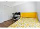 Bright bedroom with a cheerful yellow bed frame, workspace, and hardwood floors at 10374 Park Commons Dr, Orlando, FL 32832