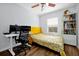 Bedroom featuring a yellow bed frame, and a workspace with dual monitors and modern desk at 10374 Park Commons Dr, Orlando, FL 32832