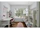 Bright bedroom featuring a bunk bed, desk, and natural light from a window at 10374 Park Commons Dr, Orlando, FL 32832