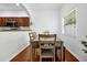 Bright dining room with hardwood floors, a window, and seating for four at 10374 Park Commons Dr, Orlando, FL 32832