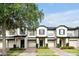 Charming townhomes featuring blue shutters, brick driveway, and well-maintained landscaping at 10374 Park Commons Dr, Orlando, FL 32832