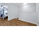 Neutral hallway leading to bedroom with white walls and hardwood flooring at 10374 Park Commons Dr, Orlando, FL 32832