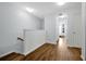 Upstairs hallway with hardwood flooring and neutral walls, leading to the bedrooms at 10374 Park Commons Dr, Orlando, FL 32832