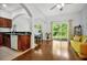 Open floor plan with hardwood floors, neutral paint, with sliding glass doors to backyard at 10374 Park Commons Dr, Orlando, FL 32832