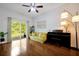 Bright living room with wood floors, sliding glass doors, and stylish furnishings at 10374 Park Commons Dr, Orlando, FL 32832