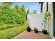 Private outdoor patio with brick pavers, surrounded by lush landscaping and a white fence at 10374 Park Commons Dr, Orlando, FL 32832