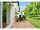 Charming brick patio with lush landscaping offering a serene outdoor retreat at 10374 Park Commons Dr, Orlando, FL 32832