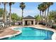 Inviting community pool area with palm trees and a shaded cabana for relaxing at 10374 Park Commons Dr, Orlando, FL 32832