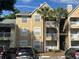 Multi-Gathering exterior showcases a tan color scheme, complemented by white trim and multiple parking spaces at 1065 S Hiawassee Rd # 1434, Orlando, FL 32835