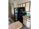 Efficient kitchen design with black appliances, neutral countertops, and ample storage space above and below at 1065 S Hiawassee Rd # 1434, Orlando, FL 32835