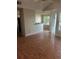 An open-concept living room featuring laminate floors, and bright, natural light through adjacent windows at 1065 S Hiawassee Rd # 1434, Orlando, FL 32835