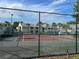 Community tennis court with well maintained fencing and lush green surroundings, perfect for recreational play at 1065 S Hiawassee Rd # 1434, Orlando, FL 32835