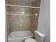 Tiled bathtub and shower combination with white trim and updated fixtures at 1079 S Hiawassee Rd # 1121, Orlando, FL 32835