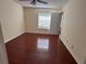 Spacious bedroom with hardwood floors, a ceiling fan, and natural light from a window at 1079 S Hiawassee Rd # 1121, Orlando, FL 32835
