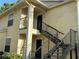 Exterior view of a two-story apartment building with staircase at 1079 S Hiawassee Rd # 1121, Orlando, FL 32835