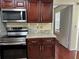Updated kitchen with stainless steel appliances, granite countertops, and wood cabinets at 1079 S Hiawassee Rd # 1121, Orlando, FL 32835