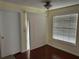 Bright room with sliding glass door, window, and cherry-look floors, offering a cozy living space at 1079 S Hiawassee Rd # 1121, Orlando, FL 32835