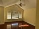 Bright living room featuring hardwood floors, vaulted ceilings, and large windows at 1079 S Hiawassee Rd # 1121, Orlando, FL 32835