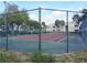Community tennis court with the residential buildings in the background at 1079 S Hiawassee Rd # 1121, Orlando, FL 32835