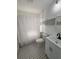 Bathroom with tiled floors, a shower/tub combo with checkered curtains, and a vanity at 111 E 8Th St, Sanford, FL 32771