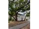 Street view of a charming home with mature trees and a landscaped yard at 111 E 8Th St, Sanford, FL 32771