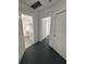 Well-maintained hallway leading to a bathroom with tiled floor and white vanity at 111 E 8Th St, Sanford, FL 32771