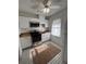 Charming kitchen featuring black-and-white tiled floor, stainless steel appliances, and white cabinetry at 111 E 8Th St, Sanford, FL 32771