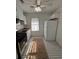 Charming kitchen featuring black-and-white tiled floor, stainless steel appliances, and white cabinetry at 111 E 8Th St, Sanford, FL 32771