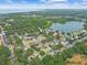 Stunning aerial view showcasing a neighborhood with mature trees, a serene lake, and proximity to the ocean at 1156 Brandy Lake View Cir, Winter Garden, FL 34787