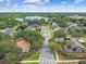 Community aerial view showcasing lush greenery, a serene lake, and well-maintained homes in a desirable neighborhood at 1156 Brandy Lake View Cir, Winter Garden, FL 34787