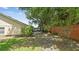 Expansive backyard with mature trees, screened-in porch, and brick privacy wall, perfect for outdoor gatherings at 1156 Brandy Lake View Cir, Winter Garden, FL 34787