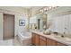 Bright bathroom with a chandelier, double sinks, and large tub at 1156 Brandy Lake View Cir, Winter Garden, FL 34787