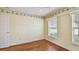 Bright bedroom with wood floors, ceiling fan, and two windows providing ample natural light at 1156 Brandy Lake View Cir, Winter Garden, FL 34787