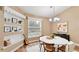 Cozy dining room with hardwood floors, natural light, and built in shelving offers charm and functionality at 1156 Brandy Lake View Cir, Winter Garden, FL 34787