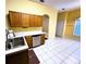 Well-lit kitchen with white tile flooring and stainless steel appliances at 1156 Brandy Lake View Cir, Winter Garden, FL 34787