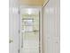 A view looking into laundry room with white tile floors, a window, and washer/dryer hookups at 1156 Brandy Lake View Cir, Winter Garden, FL 34787