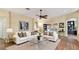 Staged living room with hardwood floors and seamless transition to outdoor patio at 1156 Brandy Lake View Cir, Winter Garden, FL 34787